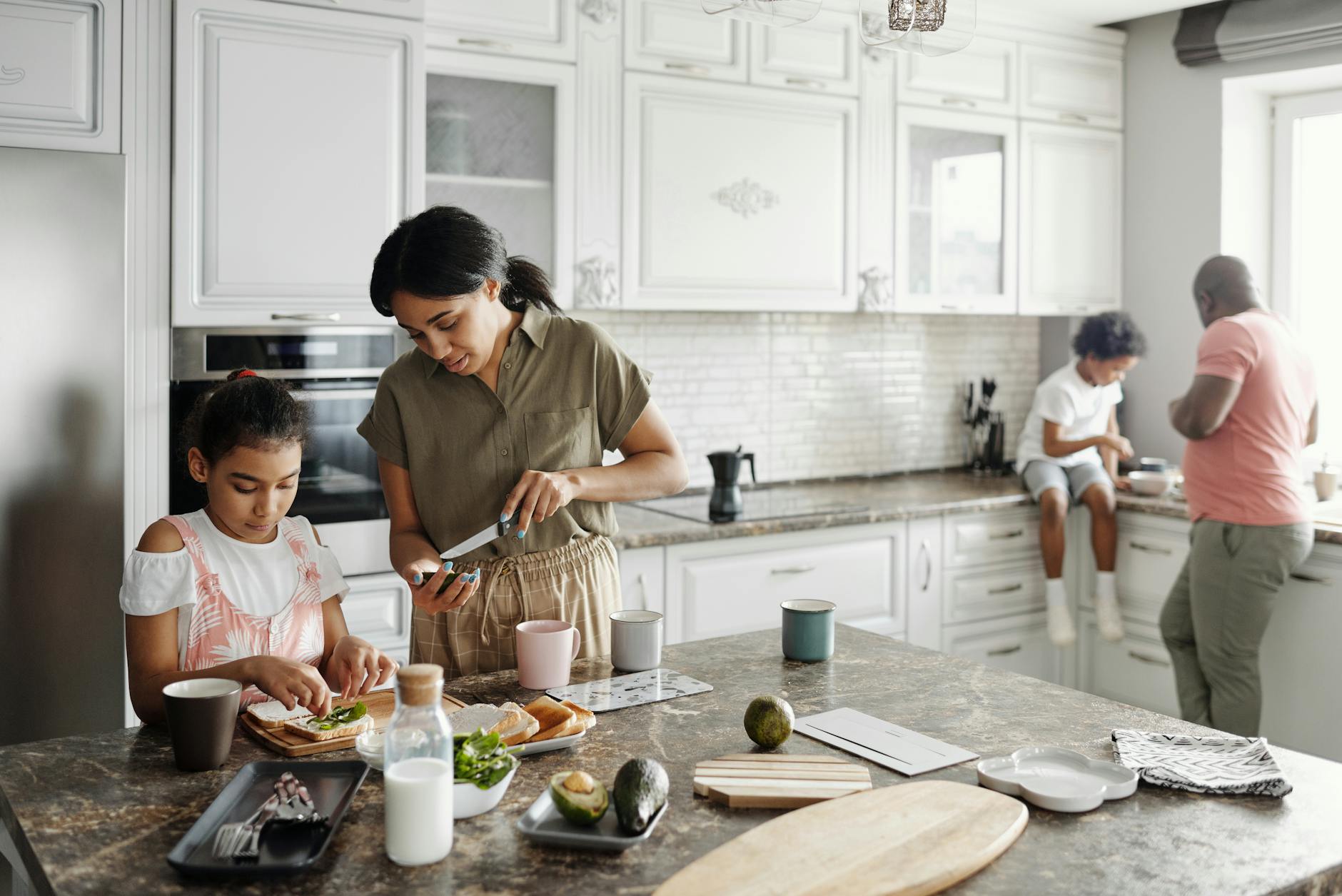 mother and daughter preparing avocado toast